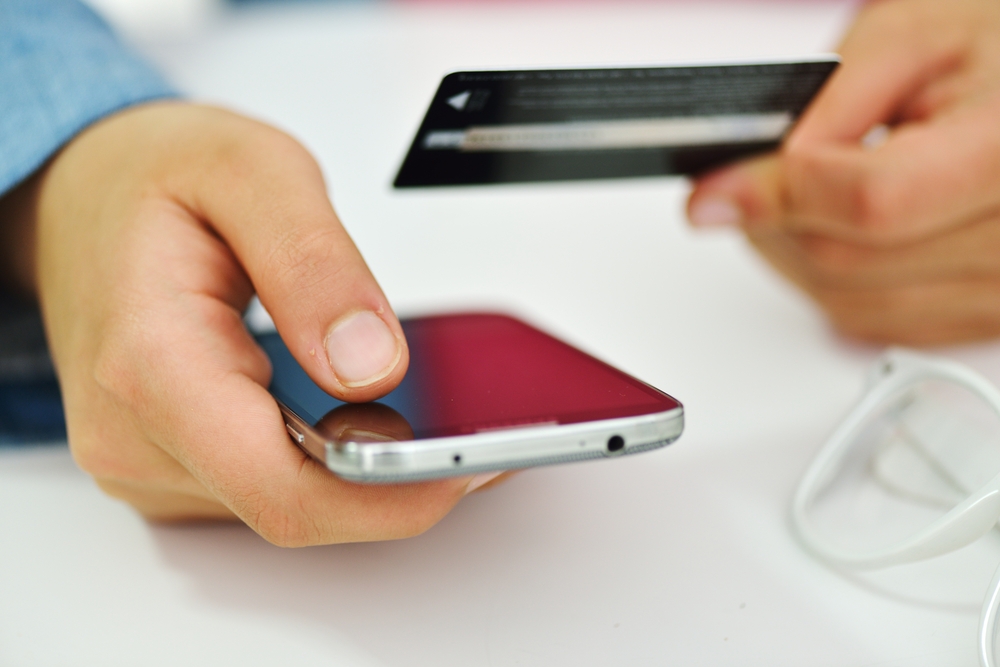 Human hand on tablet pc and credit card for shopping online